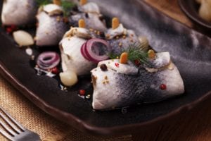 Rolled herring in vinegar, served with onions and pickles. Perfect for vodka.